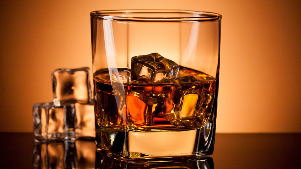 Glass filled with whisky over ice