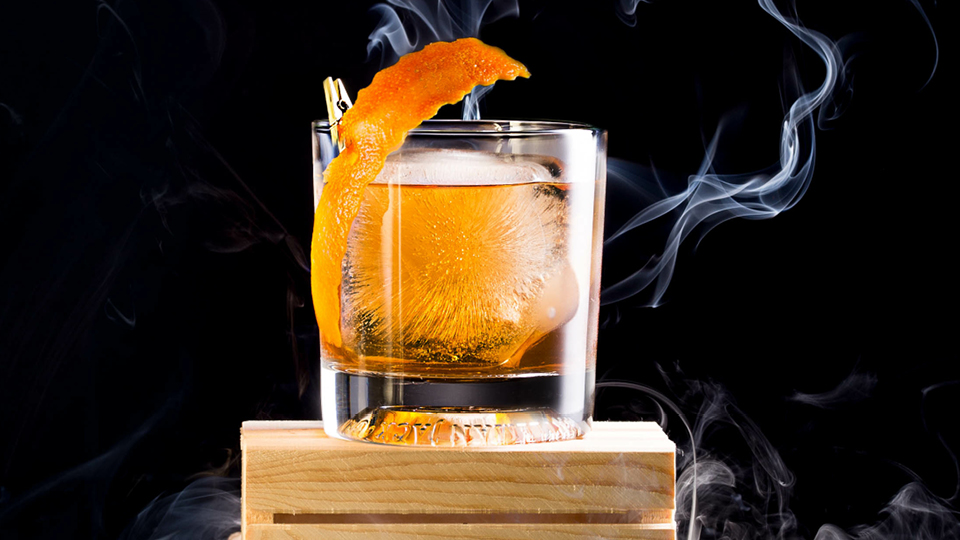 Cocktail glass with smoke in the background